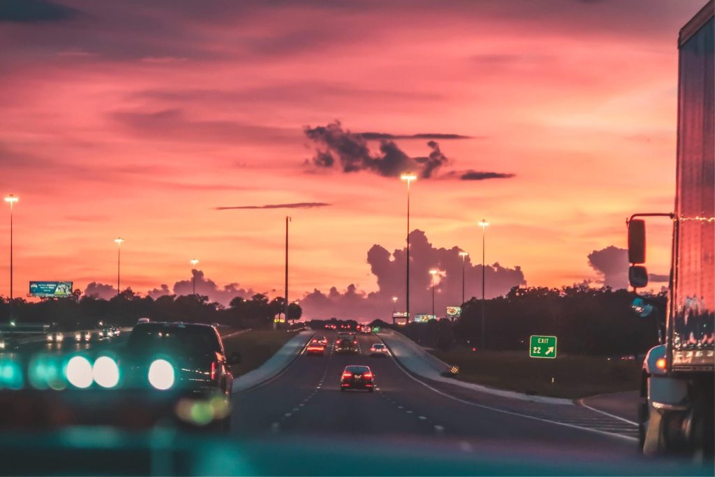 cars driving at sunset on highway