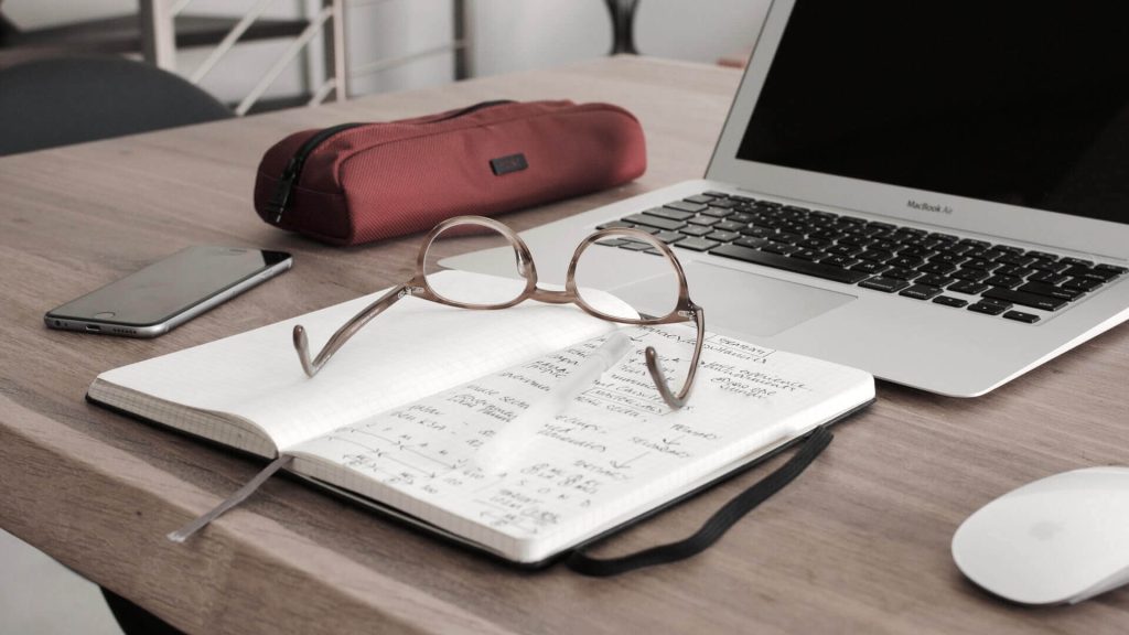 glasses laying on a journal