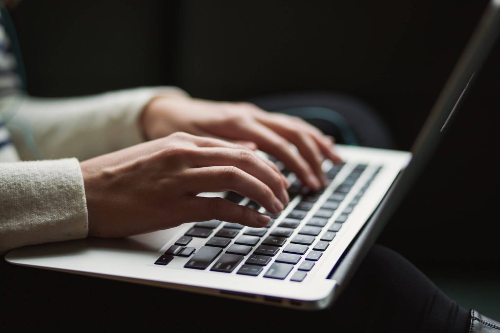 someone typing on a laptop