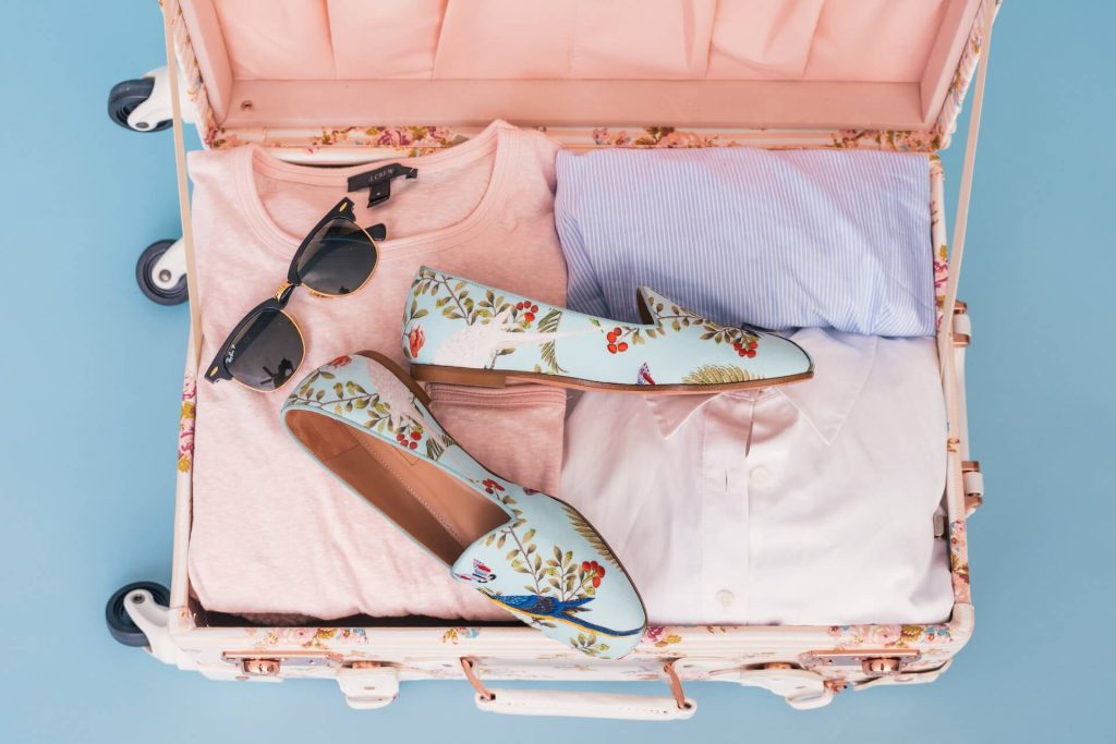 suitcase filled with clothes and shoes