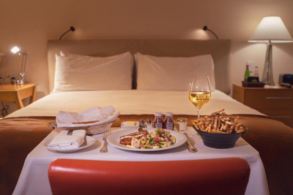 room service with food in front of bed