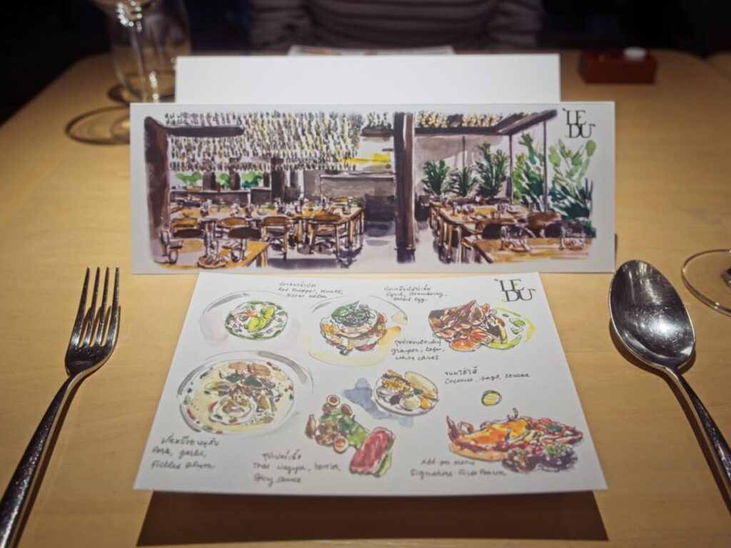 Table at Le Du with drawn menu