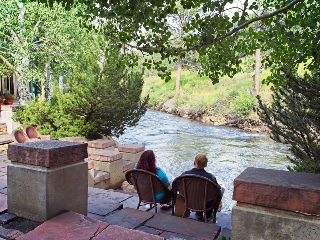 Couple sitting by the river walk in Estes Park